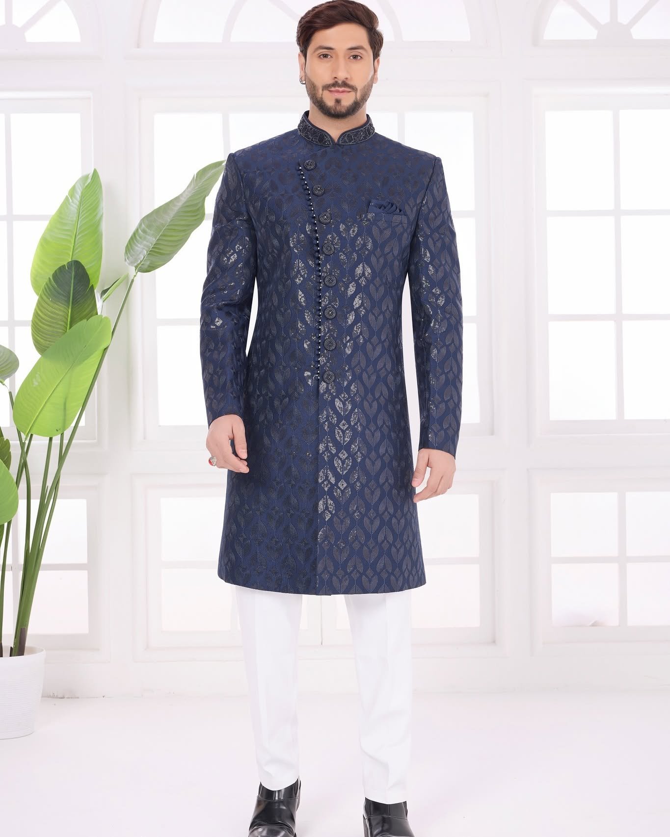 Make a powerful style statement with our Designer Navy Blue Sherwani Set Crafted with exquisite computer thread work on premium Art Silk, this elegant 3-piece jacket set is perfect for men who want a sophisticated and royal ethnic look. Paired with an Off-White Dupion Art Silk Aligarhi Pant, it is an ideal choice for weddings, receptions, engagements, parties and festive occasions.
